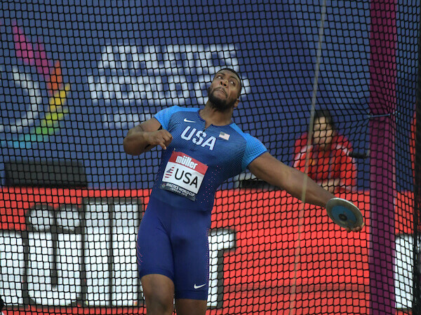 American discus thrower competing at the Athletics World Cup in London, showcasing strength and precision in the discus event at Queen Elizabeth Olympic Park, featured by HSI.net.