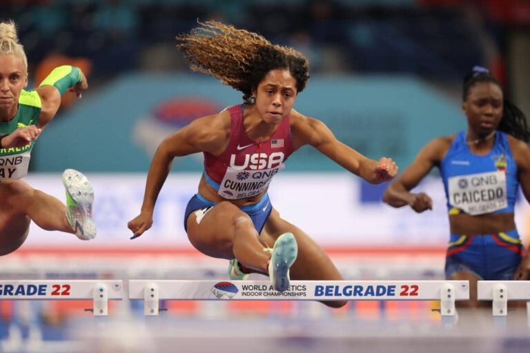 Female hurdler representing the USA competing at the World Athletics Indoor Championships in Belgrade, showcasing focus, determination, and elite athletic performance featured by HSI.net.