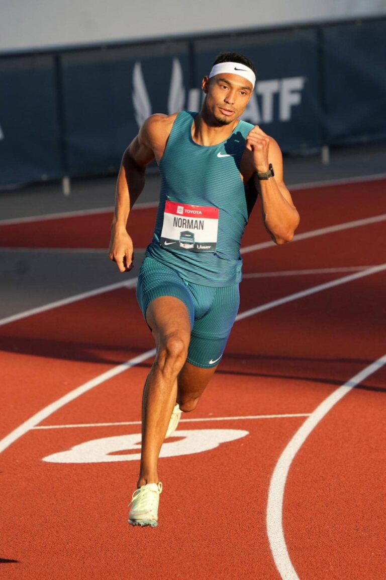 Elite sprinter powering through the curve on a professional track, showcasing strength, speed, and precision — representing HSI’s world-class track and field athletes.