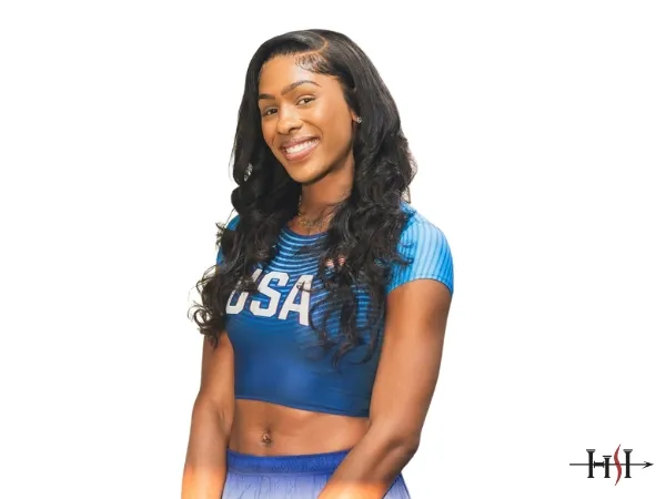 USA track and field athlete smiling confidently in blue team uniform, representing professionalism, strength, and athletic excellence