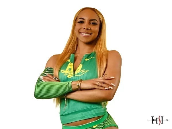 Track and field sprinter in green athletic uniform confidently posing, representing strength, speed, and elite performance in professional athletics.